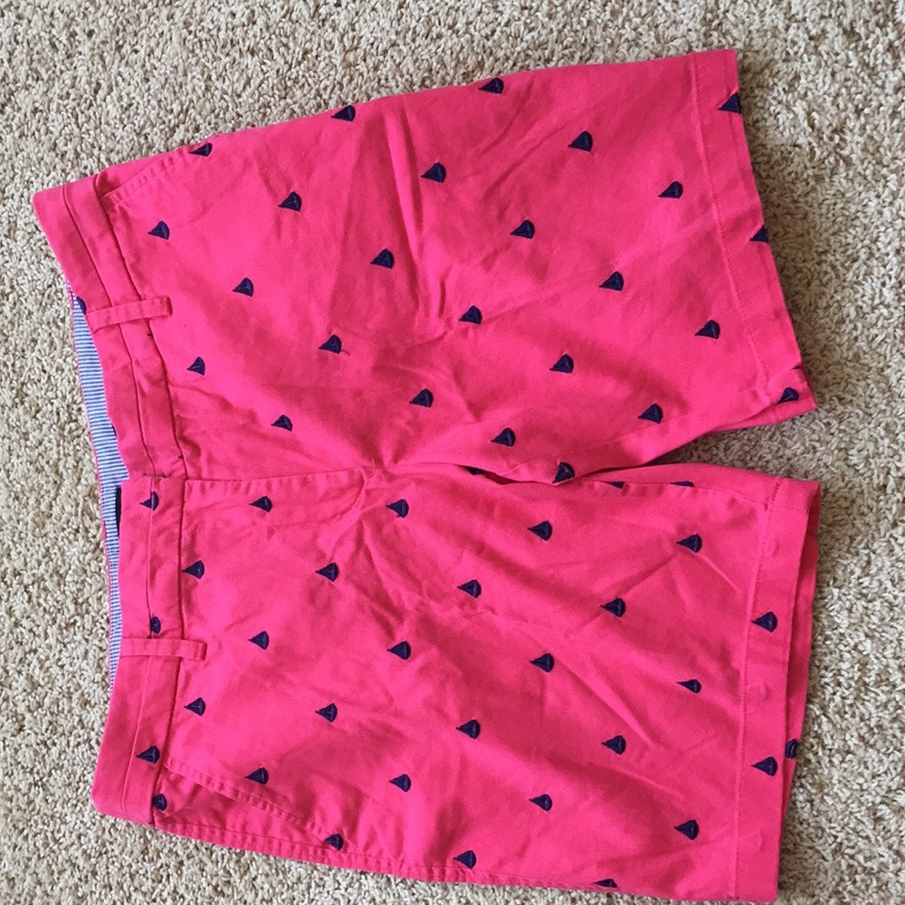 Pink shorts with embroidered navy sailboats.
